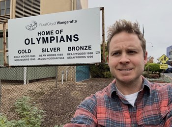 Tom Cobban visited with Wangaratta community groups this week.  The sign behind Tom commemorates the achievements of Nick Morris (basketball), James Hoggan (athlete) and Dean Woods (cyclist). - Wangaratta - May 2026